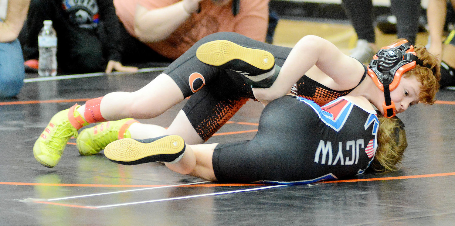 Greyson Conour (orange and black singlet) runs on the mat looking to turn Jefferson City’s Kaylenna Miesner on her back. Conour went on to win a 10-5 decision. Turner and Conour were among the 15 Owensville Wrestling Club (OWC) grapplers that finished sixth or better in their respective weight classes to advance to this weekend’s Missouri USA Region D Tournament at Moberly Area Community College in Moberly. Wrestlers that finish in the top four of their respective weight classes will advance to the Missouri USA Folkstyle Wrestling Championships at HyVee Arena in Kansas City.